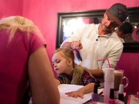 Rory O?Neil brushes his daughter Isla?s hair as Trish Woolley paints her nails during (Root) Beer and Braids at Posh Pedicure Lounge in London on Friday. The father and daughter event gives dads a chance to learn the basics of hairstyling. (CRAIG GLOVER, The London Free Press)