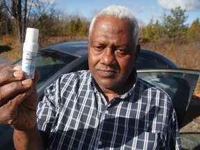 Veragoda Perera holds up his nitroglycerin spray. He says he was given a speeding ticket after trying to get help for an apparent heart attack. 
MATT DAY/ OTTAWA SUN