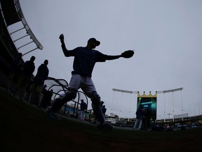 Kansas City Royals catcher Drew Butera warms up during media day for the World Series against the New York Mets in Kansas City on Oct. 26, 2015. (AP Photo/Matt Slocum)