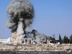 This undated photo released Aug. 25, 2015, on a social media site used by Islamic State militants, which has been verified and is consistent with other AP reporting, shows smoke from the detonation of the 2,000-year-old temple of Baalshamin in Syria's ancient caravan city of Palmyra. Activists say the Islamic State group has killed three captives on Oct. 26, 2015, in Syria’s ancient city of Palmyra by tying them to Roman-era columns at the site, then blowing the structures up with explosives. (Islamic State social media account via AP, File)