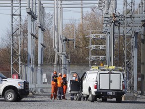 Workers arrive at the Utilities Kingston transformer station at Division and John Counter Boulevard on Tuesday morning October 27 2015. (Elliot Ferguson Kingston Whig-Standard/Postmedia Network)