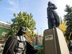 A participant dressed as Darth Vader, a character from the 'Star Wars' film, takes part in an inauguration ceremony of a Darth Vader monument, formerly a statue of Soviet founder Lenin, in the southern Ukrainian city of Odessa on October 23, 2015. (AFP/VOLODYMYR SHUVAYEV)