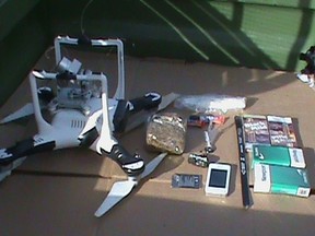 A drone that was carrying a package that contained two hacksaw blades, a cellphone, a cellphone battery, two packages of cigarettes, a hands-free device, two packs of cigars, super glue, a 5.3-ounce bag of marijuana, a 0.8 ounce bag of methamphetamine and a less than 1 gram bag of heroin, is pictured in this undated handout photo provided by the Oklahoma Department of Corrections. (REUTERS/Oklahoma Department of Corrections/Handout)