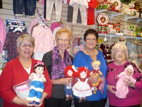 Displaying the donation of dolls are Joan Parsons, Dale Golding, Diane Genier & Aline Tousignant.