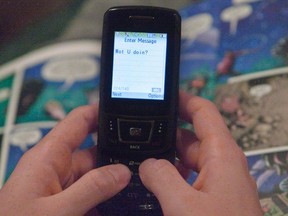 A text message is sent on a mobile phone, November 9, 2010 in Montreal. The CRTC says Canadians are spending a lot more for mobile and Internet service as they feed ever-increasing appetites for online entertainment. THE CANADIAN PRESS/Ryan Remiorz