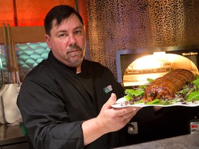 Chef Mike Smith shows off his latest creation, the Bacon Bomb, in the 519 Kitchen at Toboggan on Richmond Street in London. (CRAIG GLOVER, The London Free Pess)