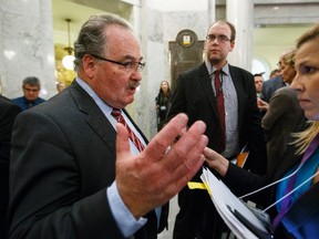 Minister of Infrastructure, Minister of Transportation, and Government House Leader Brian Mason (left) is interviewed in the rotunda after the government's delivery of Budget 2015 at the Alberta Legislature in Edmonton, Alta., on Tuesday October 27, 2015. Ian Kucerak/Edmonton Sun/Postmedia Network