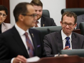 Marlin Schmidt (right), MLA for Edmonton-Gold Bar, applauds Finance Minster Joe Ceci's Budget 2015 speech on the floor of the Alberta Legislature in Edmonton, Alta., on Tuesday October 27, 2015. Ian Kucerak/Edmonton Sun/Postmedia Network