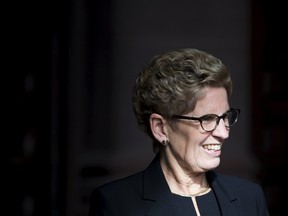 Ontario Premier Kathleen Wynne smiles as she awaits Justin Trudeau to arrive Queen's Park in Toronto, October 27, 2015. (REUTERS/Mark Blinch)