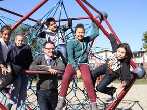 Pierre Elliott Trudeau Elementary School principal David McFall poses with his students who wrote and performed "Important to Us," produced by David Hodges, a Canadian music producer and educator. Five of the eight students who participated in the project are, from left, Aisha Khadr, Lucy Robertson, Antonio Ahualla, Crystal Gilpin and Neebin Armstrong. (Julienne Bay/Ottawa Sun)