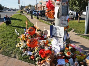 The media take photos at a makeshift memorial set up for the victims of the Saturday, Oct. 24, 2015 homecoming parade crash in Stillwater, Okla., Monday, Oct. 26, 2015. A judge has an ordered a psychological evaluation for Adacia Chambers. She is accused of driving her car into Oklahoma State's homecoming parade, killing four people and injuring dozens of others.  (AP Photo/Sue Ogrocki)