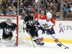 Florida Panthers right winger Jaromir Jagr carries the puck around the net as Pittsburgh Penguins goalie Marc-Andre Fleury and centre Nick Bonino defend at the CONSOL Energy Center in Pittsburgh on Oct. 20, 2015. (Charles LeClaire/USA TODAY Sports)