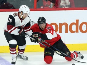 Arizona Coyotes' Max Domi (16) and Ottawa Senators' Curtis Lazar (27) battle for the puck during first period NHL hockey action in Ottawa Saturday, October 24, 2015. After being hit late in the first period, Lazar did not return. THE CANADIAN PRESS/Fred Chartrand