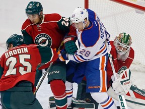 Lauri Korpikoski and Matthew Dumba battle in front of the Wild net during the first period of Tuesday's game in St. Paul, Minn. (AP Photo)