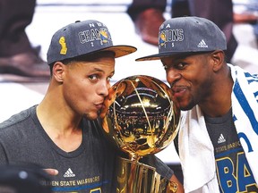 Stephen Curry (left) and Andre Iguodala celebrate Golden State’s NBA championship last year. (AFP)