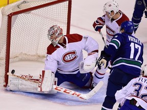 Oct 27, 2015; Vancouver, British Columbia, CAN; Vancouver Canucks forward Radim Vrbata (17) scores against Montreal Canadiens goaltender Carey Price (31) and defenseman Alexei Emelin (74) during the third period at Rogers Arena. The Vancouver Canucks won 5-1. Mandatory Credit: Anne-Marie Sorvin-USA TODAY Sports