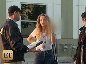 Johnny Depp is seen with a "police officer" and wife Amber Heard in a clip from "Overhaulin'."