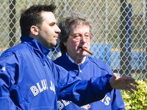 Toronto Blue Jays general manager Alex Anthopoulos (L) and President and CEO Paul Beeston talk during workouts at the team's MLB baseball spring training facility in Dunedin, Florida February 17, 2013.  REUTERS/Fred Thornhill