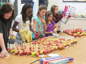 Raymond Joanisse/For The Sudbury Star                             
Five elementary school students from Felix Ricard school busily worked to prepare and package 275 candy apples.