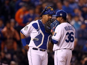Salvador Perez #13 of the Kansas City Royals meets with Edinson Volquez #36 of the Kansas City Royals on the pitcher's mound in the third inning against the New York Mets during Game One of the 2015 World Series at Kauffman Stadium on October 27, 2015 in Kansas City, Missouri.   Doug Pensinger/Getty Images/AFP