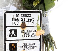 Flowers have been set up Wednesday Feb. 6, 2013, at the 156 Street and 110 Avenue crosswalk following a Feb. 4, 2012 fatal car pedestrian collision, in Edmonton, Alberta. David Bloom/Edmonton Sun