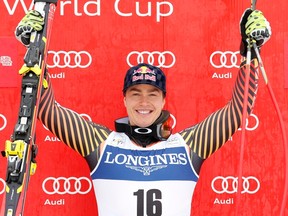 First placed Erik Guay of Canada celebrates on the podium after men's World Cup downhill event in Kvitfjell March 1, 2014.    REUTERS/Cornelius Poppe/NTB Scanpix