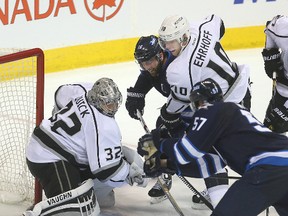 Winnipeg Jets left winger Andrew Ladd (#16), Los Angeles Kings defenceman Christian Ehrhoff (#10) and Winnipeg Jets defenceman Tyler Myers (#57) fight for the puck in front of Los Angeles Kings goalie Jonathan Quick during NHL hockey in Winnipeg, Man. Tuesday October 27, 2015.