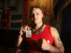 Top Glove Boxing's Matthew Cooper shows the gold medal he won at the recent Bronze Gloves tournament. The 22-year-old made some major changes in his life and boxing has been a catalyst for him.