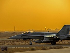 File photo of a Cold Lake CF-18 Hornet from Air Task Force-Iraq taxis on the runway before a night patrol during Operation IMPACT in Kuwait, on February 1, 2015. Canadian Forces/Combat Camera/DND/Files