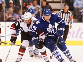 Kyle Chipchura and Byron Froese fight for the puck in the second period  as the Toronto Maple Leafs take on the Arizona Coyotes at the Air Canada Centre in Toronto Oct. 26, 2015. (Stan Behal/Toronto Sun/Postmedia Network)