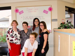 Dr. Bev Burton, Chalsey Peeters, Lais Morrow, Lisa Secretan,  and Ashley Conley of the Associate’s Clinic pose in front of the Breast Cancer information board. The staff are on a mission to get the word out about breast cancer screening during the month of October. John Stoesser photo/Pincher Creek Echo.