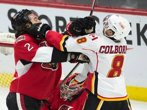 Calgary Flames center Joe Colborne and Ottawa Senators defenseman Jared Cowen continue to battle in front of the Ottawa net after the whistle during first period NHL action Wednesday October 28, 2015 in Ottawa. THE CANADIAN PRESS/Adrian Wyld