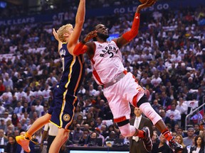 DeMarre Carroll of the Toronto Raptors puts one up on Chase Budinger of the Indiana Pacers during NBA action at the Air Canada Centre in Toronto on Oct. 28, 2015. (Dave Abel/Toronto Sun/Postmedia Network)
