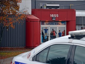 OTTAWA — Oct 29, 2015 - Cops investigate a threat at Louis Riel High School in Blackburn Hamlet on Thurs. Oct. 29, 2015. The school is closed for the day. (SAM COOLEY/OTTAWA SUN/POSTMEDIA NETWORK)