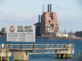 A sign posted on the dock near the Shell plant in Corunna, shown here on Thursday October 29, 2015 near Sarnia, Ont., warns against anchoring in a section of the St. Clair River where pipelines cross between Michigan and Ontario. (Observer file photo)