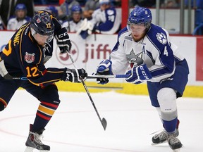 Barrie Colts Kevin Labanc and Sudbury Wolves Patrick Murphy fight for the puck during OHL exhibition action from the Sudbury Community Arena in Sudbury, Ont. on Friday September 18, 2015.