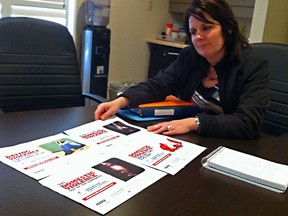 Sonya McMahon explains her committee's designs for the domestic abuse awareness billboards. The Chatham-Kent Domestic Abuse Community Coordination Committee is paying for billboards in Chatham, Tilbury, Wallaceburg, and Blenheim to raise awareness for the month. Photo taken in Chatham Oct. 29. Louis Pin // Chatham This Week