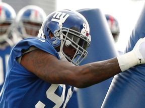 New York Giants’ Jason Pierre-Paul works out at practice on Thursday in New Jersey. Pierre-Paul is back more than three months after losing a finger in a July 4 fireworks accident. (AP/PHOTO)