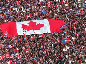 A large Canadian flag is passed through a crowd in this Friday, Oct. 27, 1995 file picture, as thousands streamed into Montreal from all over Canada to join Quebecers rallying for national unity three days before a referendum that could propel Quebec toward secession. Sunday marks the 10th anniversary of the Quebec sovereignty referendum vote that was held on Oct. 30, 1995. THE CANADIAN PRESS/Ryan Remiorz
