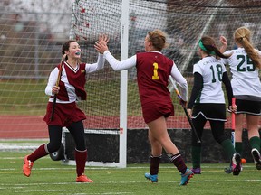 Regiopolis-Notre Dame Panthers’ Jenn Cowan, left, celebrates her goal with teammate Lilly Dickson against the Holy Cross Crusaders during the Kingston Area Secondary Schools Athletic Association girls field hockey final at the CaraCo Home Field on Thursday. Regiopolis won 2-1 to claim its fifth straight title. (Ian MacAlpine/The Whig-Standard)