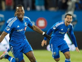 Montreal Impact’s Didier Drogba, left, celebrates after scoring against Toronto FC as teammate Dilly Duka looks on in Montreal on Thursday, October 29, 2015. (THE CANADIAN PRESS/Graham Hughes)