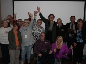 Volunteers and representatives from benefiting organizations celebrate as      results come in for the ATCO Edmonton Sun Christmas Charity Auction. Photo by Michael DiMassa/Catholic Social Services