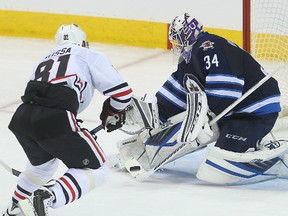 Winnipeg Jets goalie Michael Hutchinson stops Chicago's Marian Hossa on a breakaway, just one of many huge saves he made in his team's 3-1 win Thursday night.