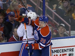 Leon Draisaitl checks Tomas Plekanec into the boards during the first period of Thursday's game at Rexall Place. (Perry Mah, Edmonton Sun)
