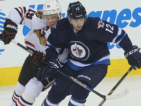 Jonathan Toews & Drew Stafford tangle at MTS on Oct. 29, 2015. (BRIAN DONOGH/Winnipeg Sun)