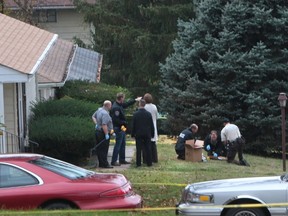 In a Wednesday, Oct. 28, 2015 photo, police officers investigate at the scene of a shooting on Paddington Drive in Normandy, Mo. Authorities say a St. Louis-area officer who exchanged gunfire with an 18-year-old suspect never hit him, even as the suspect’s father questioned police claims that the suspect killed himself. Amonderez Green of Florissant died early Thursday, 14 hours after a confrontation with a Normandy officer.  (Chris Lee/St. Louis Post-Dispatch via AP)