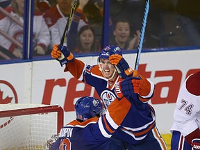 Connor McDavid celebrates Benoit Pouliot's game-tying goal against the Canadiens during the second period of Thursday's game at Rexall Place. (Perry Mah, Edmonton Sun)