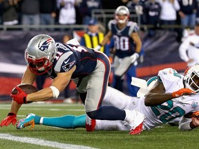 FOXBORO, MA - OCTOBER 29: Julian Edelman #12 of the New England Patriots scores a touchdown during the fourth quarter against the Miami Dolphins at Gillette Stadium on October 29, 2015 in Foxboro, Massachusetts.   Jim Rogash/Getty Images/AFP== FOR NEWSPAPERS, INTERNET, TELCOS & TELEVISION USE ONLY ==