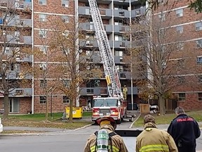 Fire crews work to contain an apartment fire on the eighth floor at 3360 Paul Anka Dr., on Friday morning. (Sam Cooley Ottawa Sun / Postmedia Network)