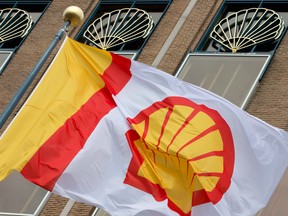 In this 2014 file photo, a flag bearing the company logo of Royal Dutch Shell, an Anglo-Dutch oil and gas company, flies outside the head office in The Hague, Netherlands. (Peter Dejong/AP)